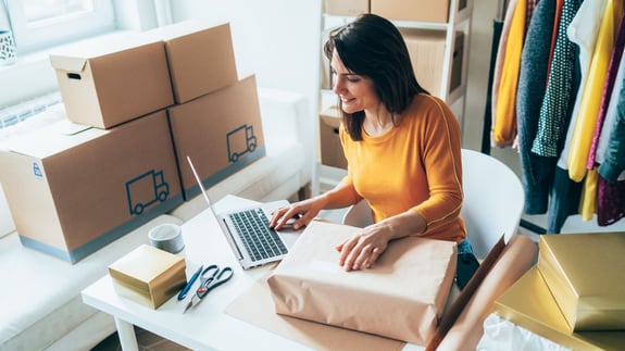 A small business owner working with retail management software.