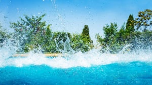 Splash into success with pool business software: A pool busy being splashed into. 