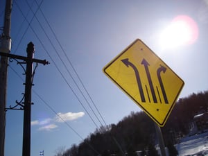 A road sign showing three options ahead. 