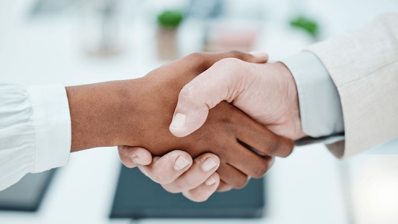 Two people buys shaking hands