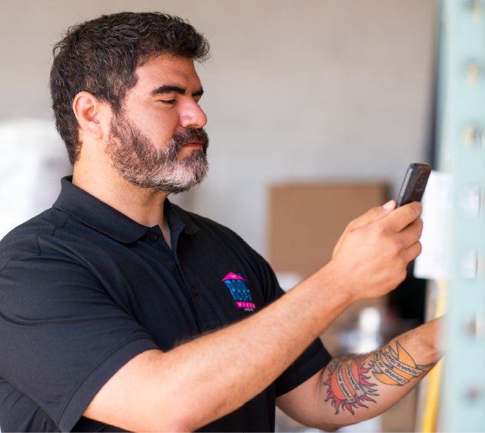 pool service worker using his mobile phone